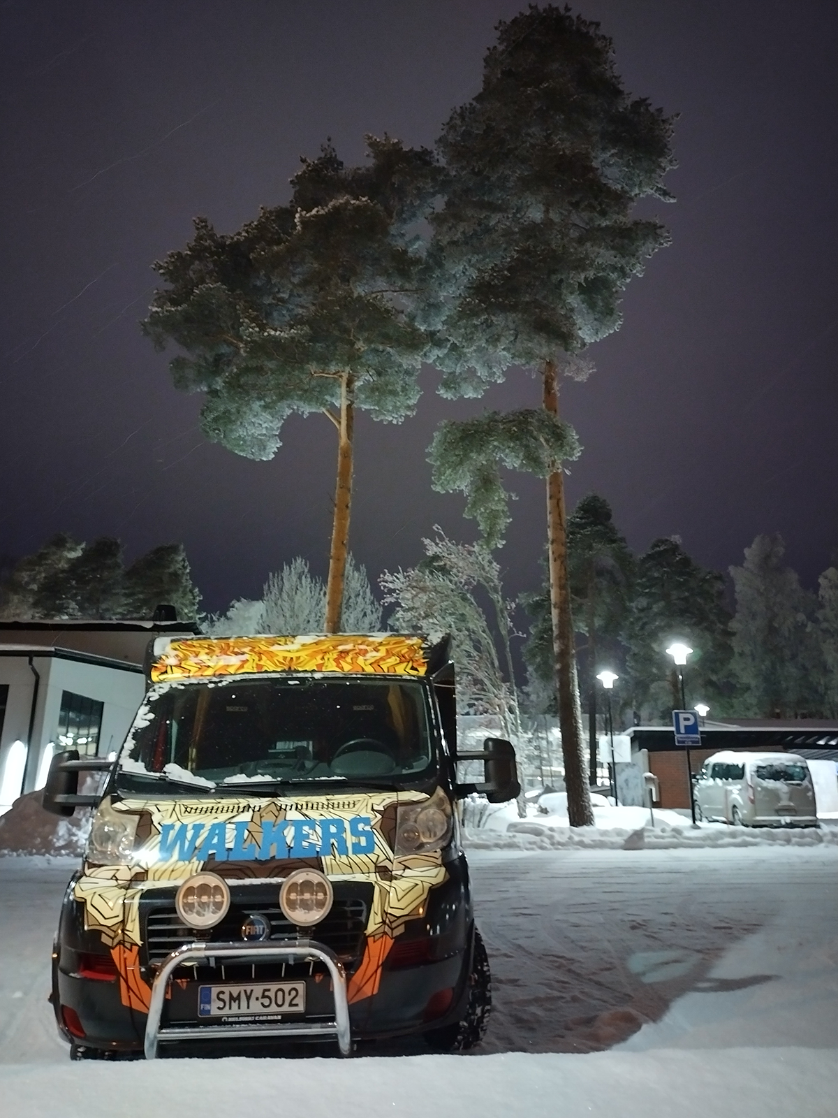 Wauto pimeässsä talvi-illassa lumen keskellä